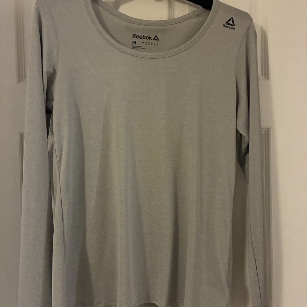 NWOT Ladies Grey Medium Reebok long sleeve Athletic top with slightly open back.